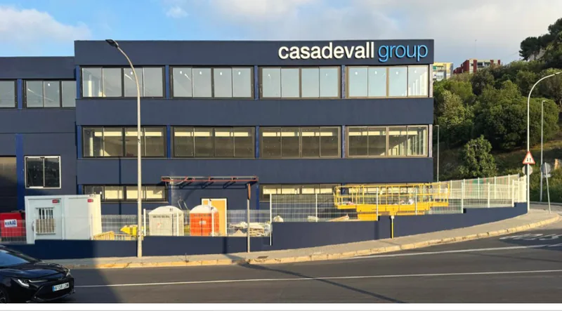 The Casadevall Group headquarters, a dark three-storey office and factory building.