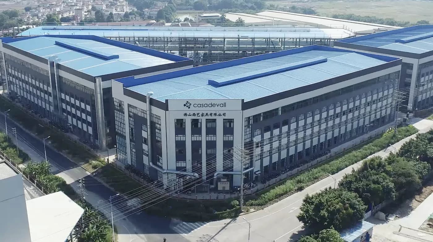 The Casadevall China plant in Foshan seen from the air - blue-roofed halls around a five-storey block.