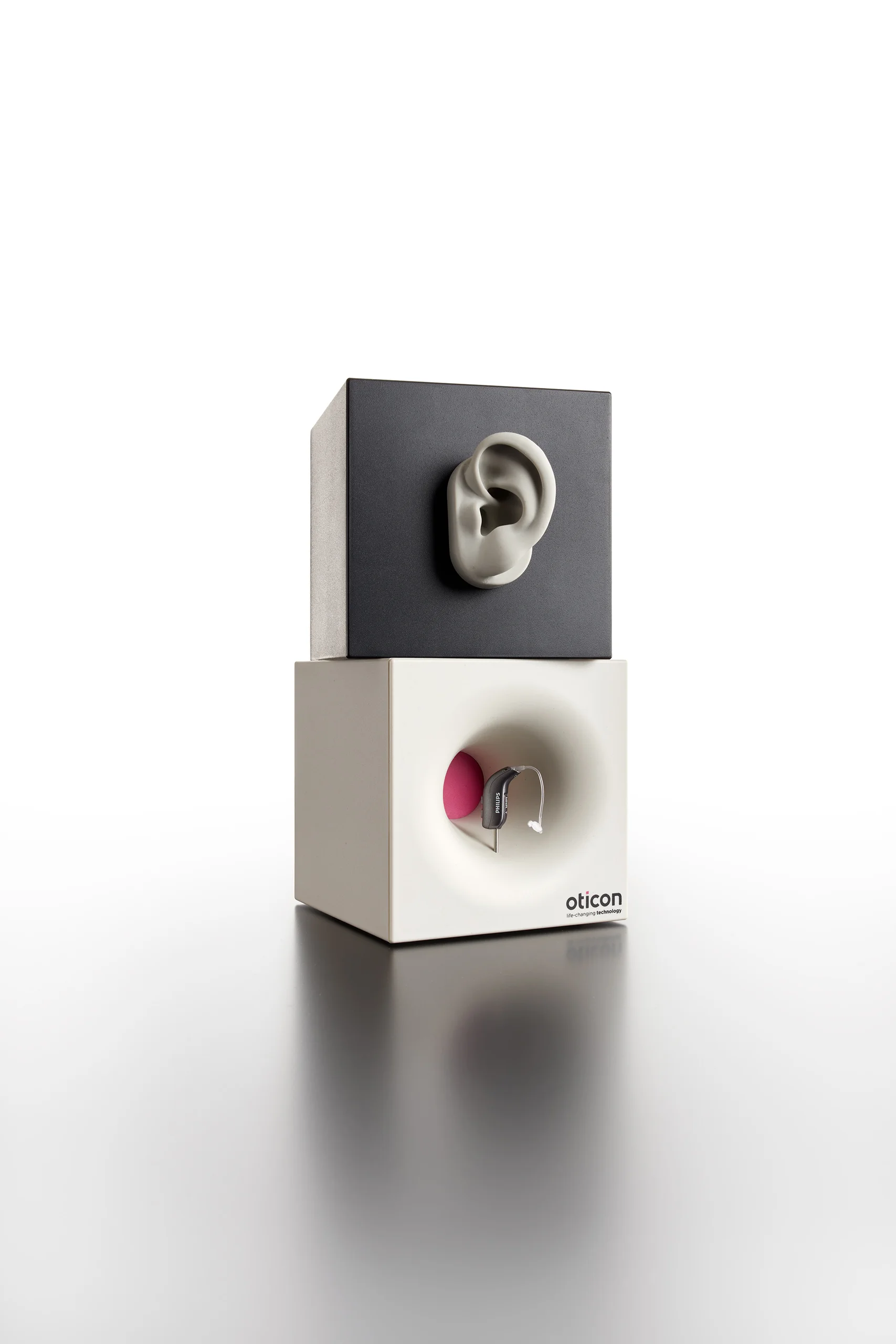 Oticon: Hearing device product display produced by Casadevall Group.
